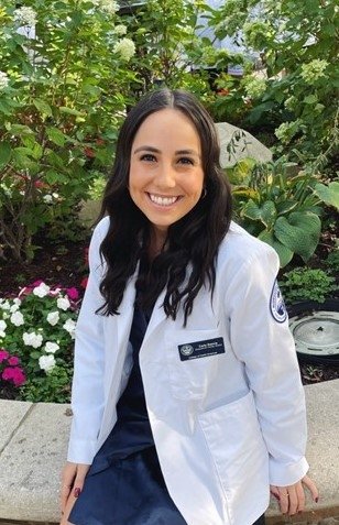 Carly Rascia in a white coat.