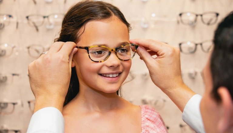 girl being fitted for glasses